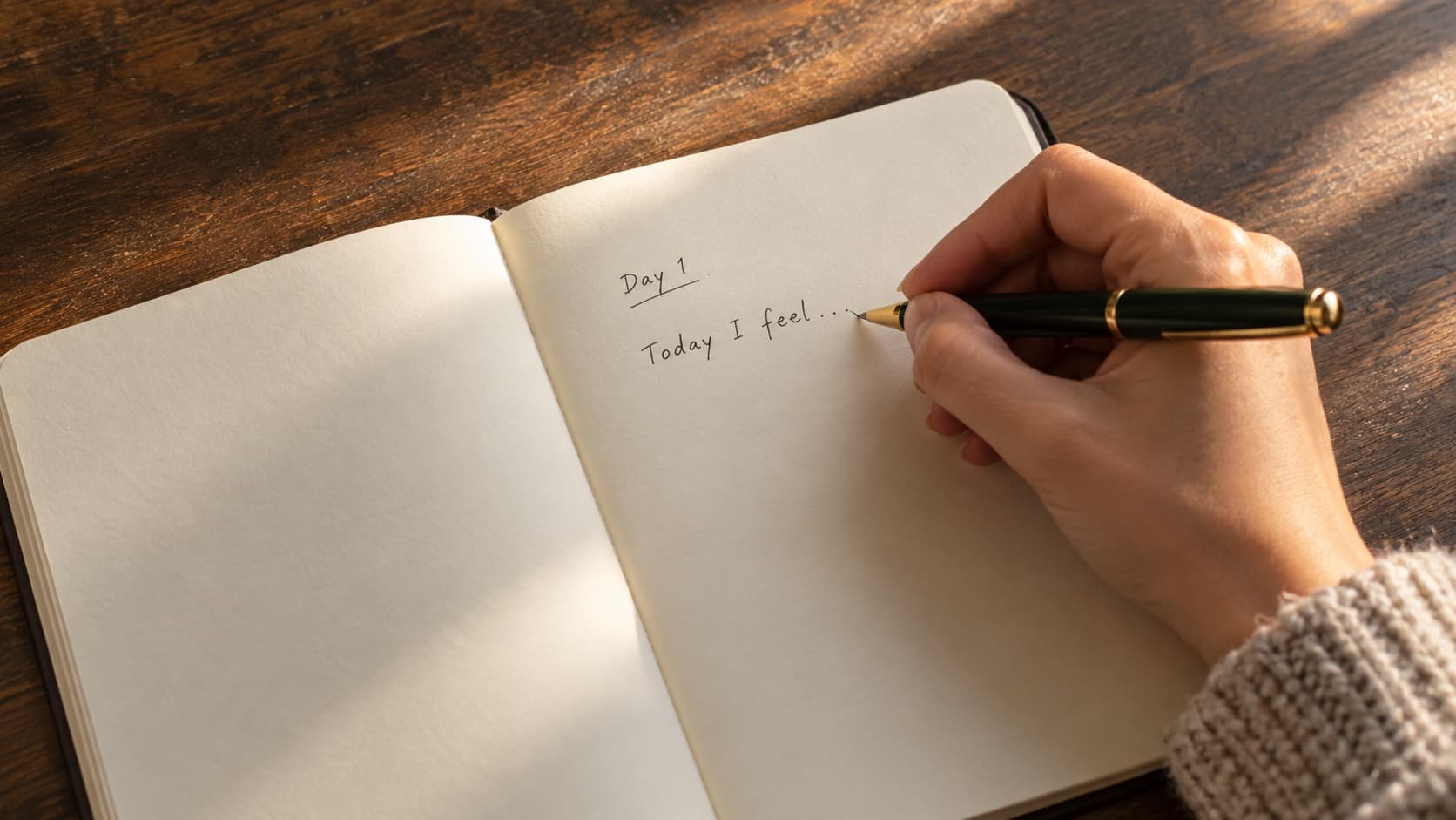 A hand writing a first journal entry headed Day 1, beginning with Today I feel, in warm morning light